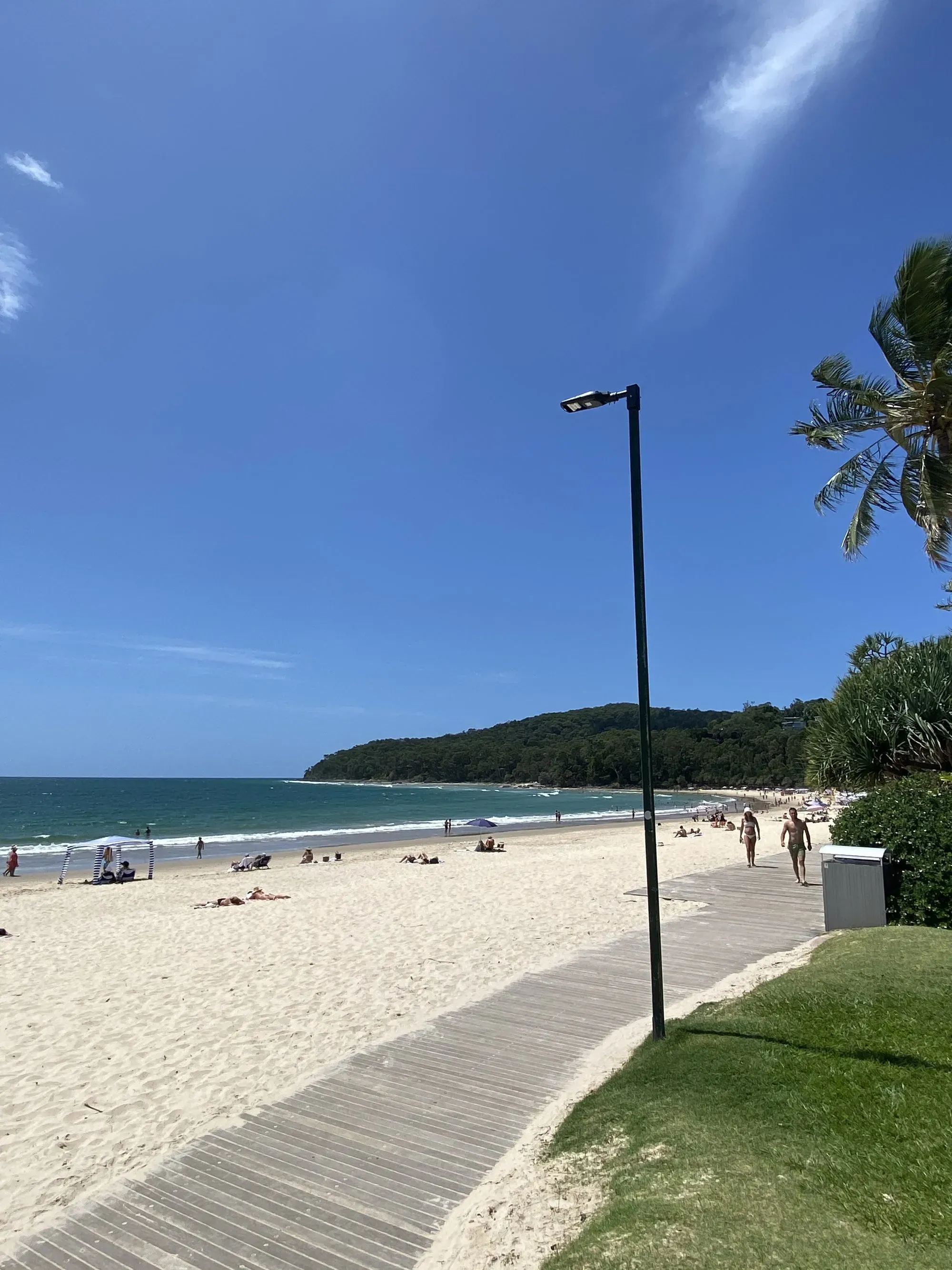 Noosa Main Beach boardwalk with an Andromeda pole-mount luminaire against blue sky